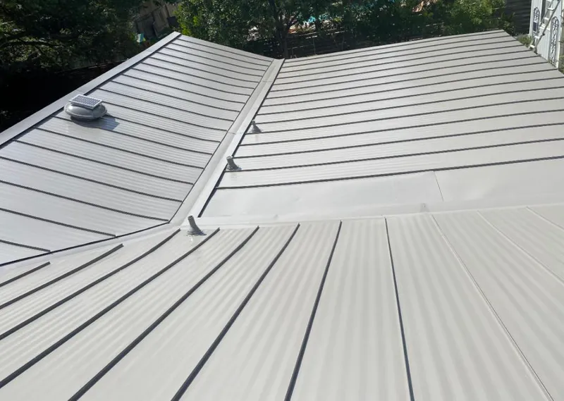 Solar attic fan installed on a metal roof for Roof Ventilation in Marquette